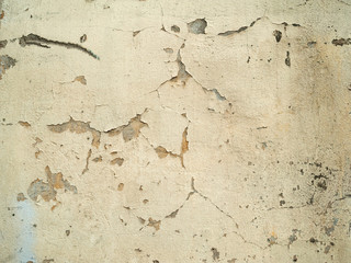 Texture of old wall covered with yellow stucco