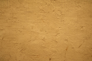 Texture of old wall covered with yellow stucco