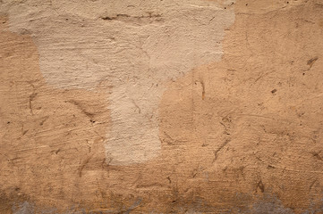 Texture of old wall covered with brown stucco