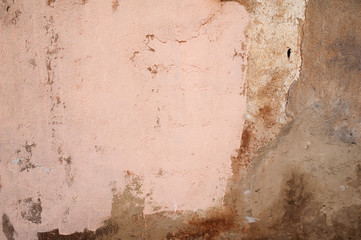 Texture of old wall covered with pink stucco