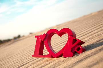 The word love and the sand in the background