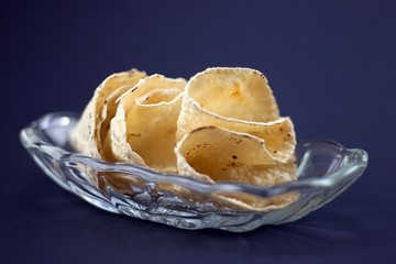 Indian Papadum crisps in a glass bowl