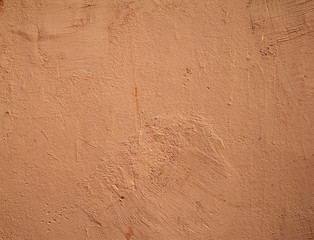 Texture of old wall covered with pink stucco