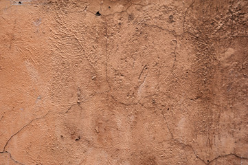 Texture of old wall covered with brown stucco