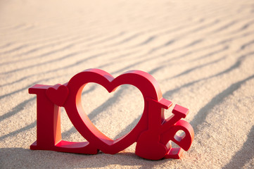 The word love and the sand in the background