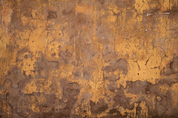 Fototapeta premium Texture of old wall covered with yellow stucco