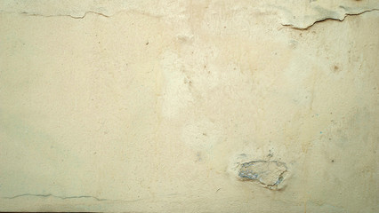 Texture of old wall covered with yellow stucco
