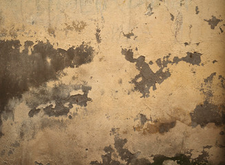 Texture of old wall covered with yellow stucco