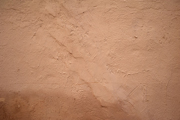 Texture of old wall covered with pink stucco