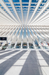 Modern railway station with transparent ceiling and blue sky