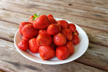 Strawberry plate on the wooden table