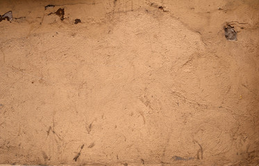 Texture of old wall covered with brown stucco