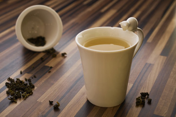Green tea in decorated tea cup on wood table clean