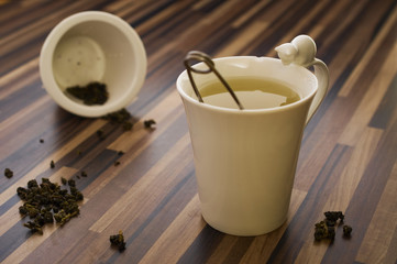 Green tea in decorated tea cup on wood table clean