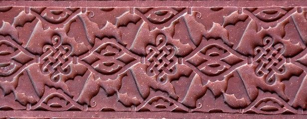 Stone pattern on a temple wall in Red Fort, Agra