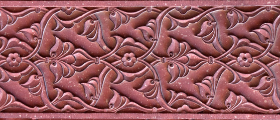 Stone pattern on a temple wall in Red Fort, Agra