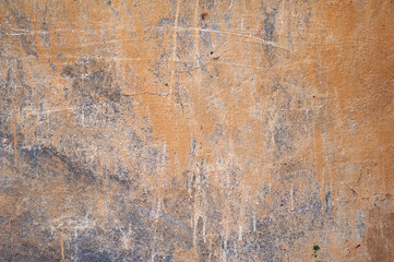 Texture of old wall covered with yellow stucco
