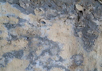 Texture of old wall covered with yellow stucco