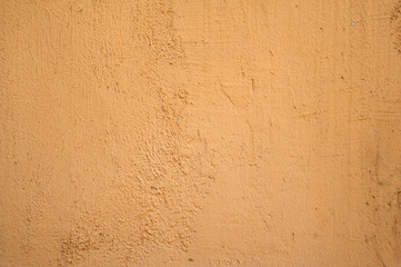 Texture of old wall covered with yellow stucco