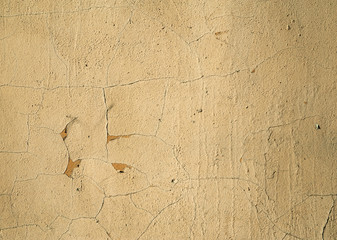 Texture of old wall covered with yellow stucco