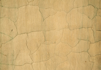 Texture of old wall covered with yellow stucco