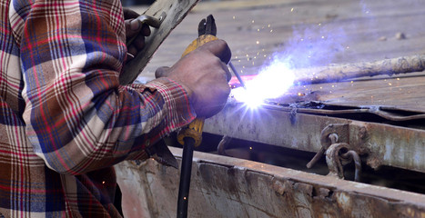 Dangerous welding without protective work wear - obrazy, fototapety, plakaty