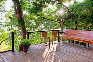 Wooden deck with benches and chair in the backyard