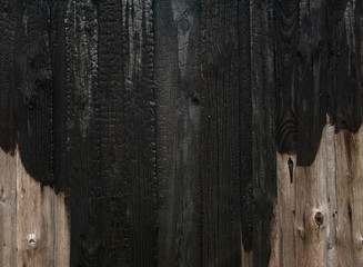 Charred wooden house wall after fire