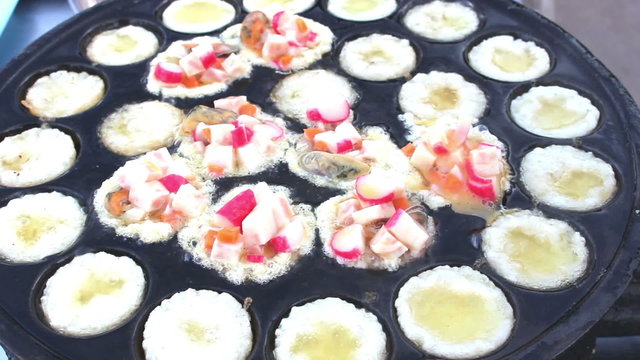 man cooking  Kanom Krok Seafood Kind Sweetmeat Of Thai