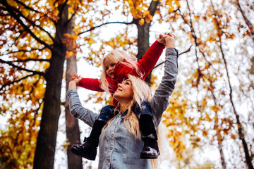 Mother with daughter in autumn park