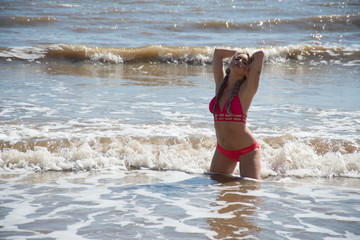 Young woman in a bikini in the sea.