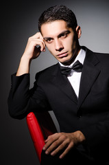 Young businessman in dark studio