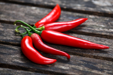 Organic Red Chili Hot Peppers on old wooden table. background.