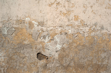 Texture of old wall covered with yellow stucco