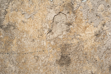 Texture of old wall covered with yellow stucco