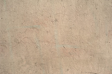 Texture of old wall covered with yellow stucco