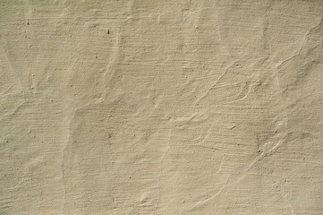 Texture of old wall covered with yellow stucco