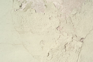 Texture of old wall covered with yellow stucco