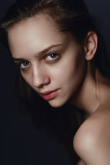 Fototapeta premium Portrait of a beautiful young brunette woman in the studio on a