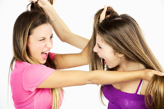 Two teenager friends fighting pulling long hair isolated