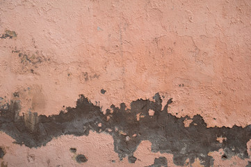 Texture of old wall covered with pink stucco