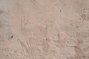 Texture of old wall covered with pink stucco