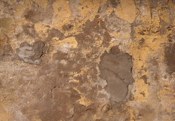 Texture of old wall covered with yellow stucco