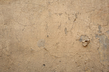 Texture of old wall covered with yellow stucco
