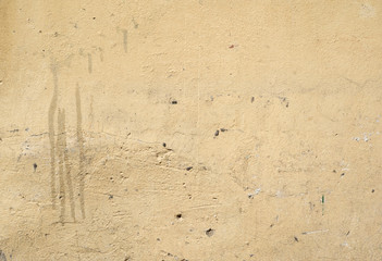 Texture of old wall covered with yellow stucco