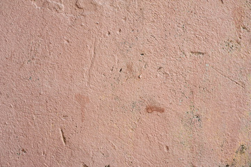Texture of old wall covered with pink stucco