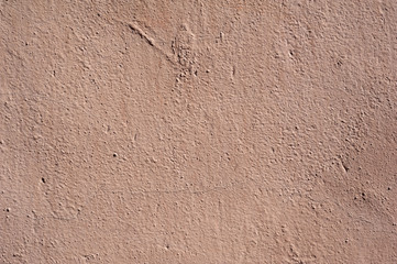 Texture of old wall covered with pink stucco