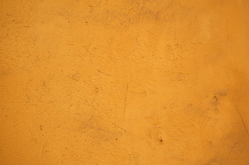 Texture of old wall covered with yellow stucco