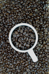White mug and coffee beans background