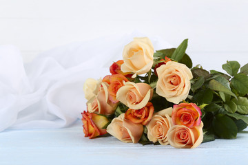 Bouquet orange roses on blue wooden background